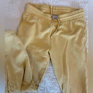 Aritzia Tna Cozy Fleece Boyfriend yellow sweatpants.